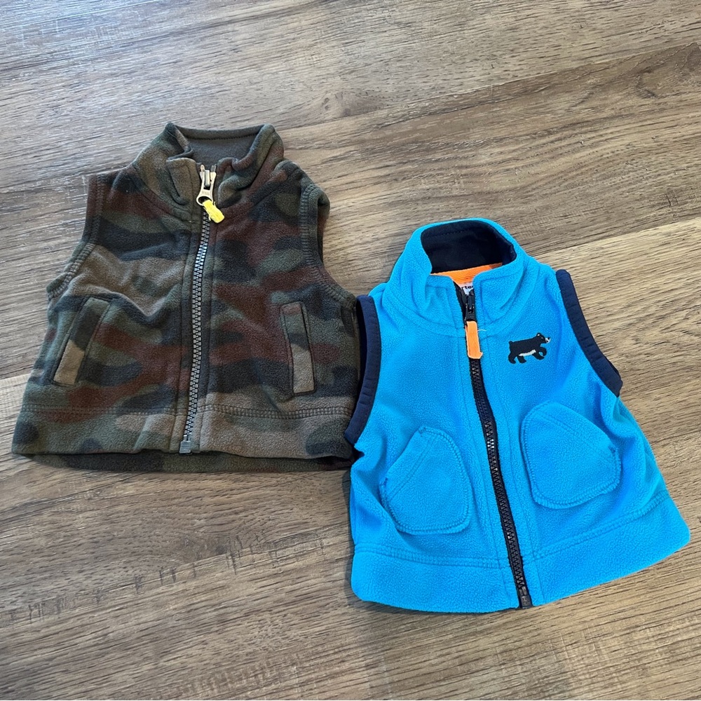 Two Carter’s zip up fleece vests, size newborn